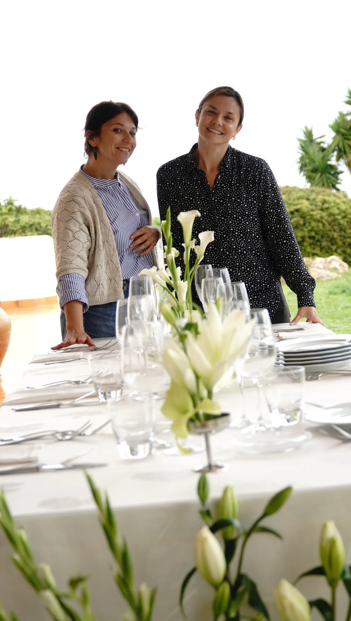 Mara with a colleague, setting an outdoor table